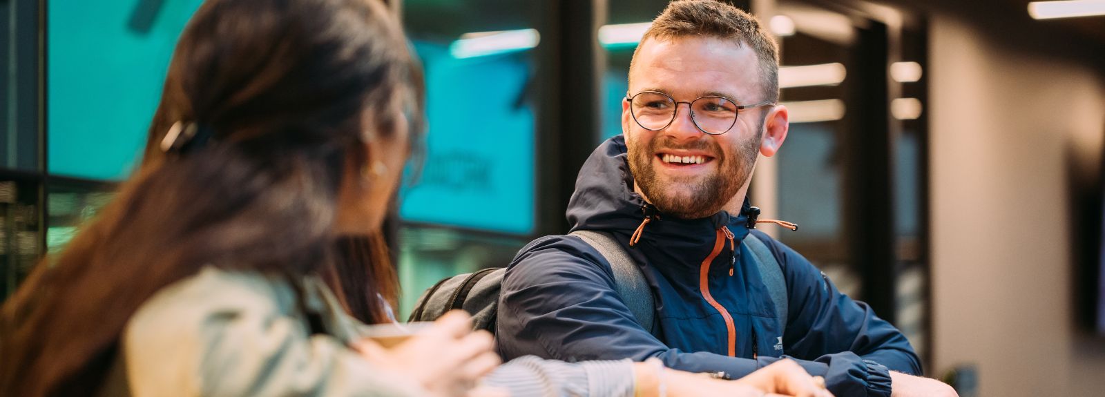 male student standing talking to a female student